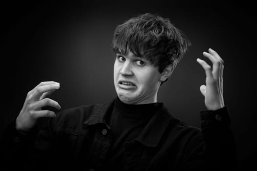 portrait of crazy young man with awesome hairdo grimacing . black and white