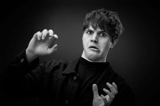 portrait of crazy young man with awesome hairdo grimacing . black and white