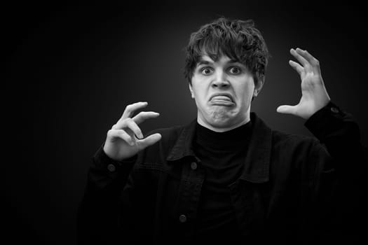 portrait of crazy young man with awesome hairdo grimacing . black and white