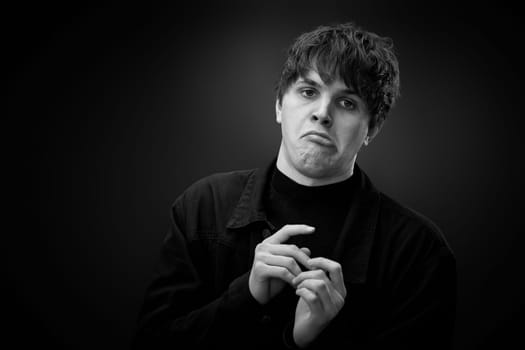 portrait of crazy young man showing the tongue and grimacing . black and white