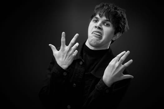 portrait of crazy young man with awesome hairdo grimacing . black and white