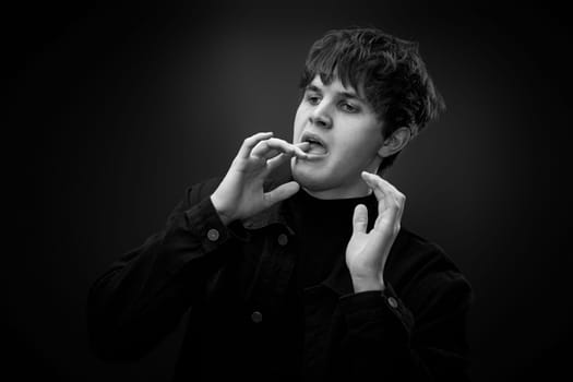 portrait of crazy young man with awesome hairdo grimacing . black and white