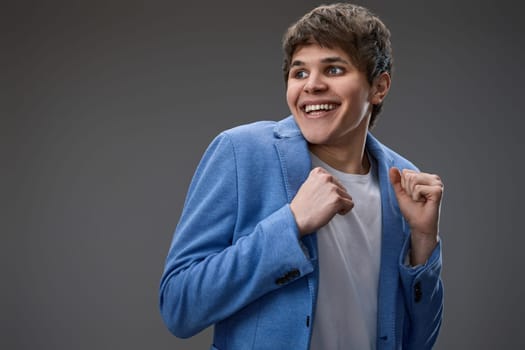 happy shocked man with surprise expression and excited face on gray studio background