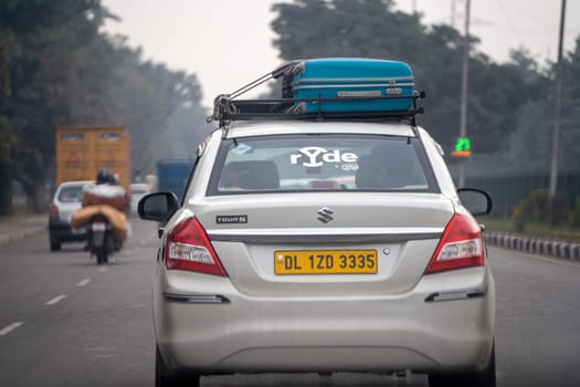 Chandigarh, India - circa 2023: Sedan car with sticker for Ryde by Redbus a taxi cab hailing startup for travelling intercity for business, vacation or fun