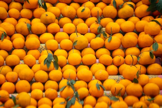 oranges kinnu citrus fruit piled up at a roadside stall showing how farmers traditionally sell this local fruit in India for eating and juice as a healthy item in summer months