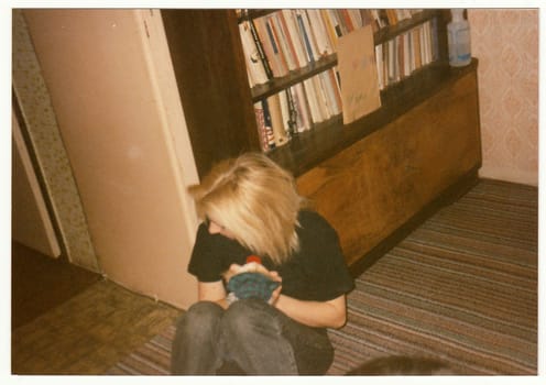 THE CZECHOSLOVAK REPUBLIC - CIRCA 1990s: Retro photo shows a sad girl at the party.