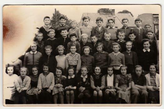 THE CZECHOSLOVAK SOCIALIST REPUBLIC - CIRCA 1960s: A vintage photo shows schoolmates. Photo has error obtained during photo process.