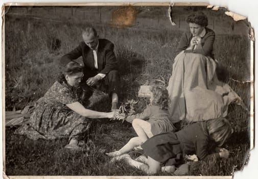 THE CZECHOSLOVAK SOCIALIST REPUBLIC - CIRCA 1960s: Vintage photo shows family on meadow.