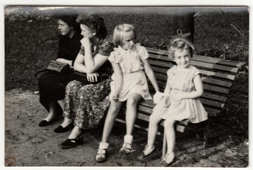 THE CZECHOSLOVAK SOCIALIST REPUBLIC - CIRCA 1960s: Vintage photo shows mothers and their daughters. Antique black & white photo.