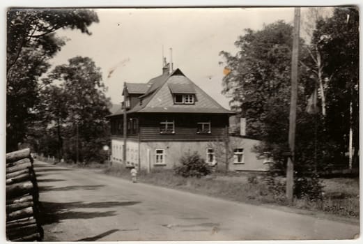 THE CZECHOSLOVAK SOCIALIST REPUBLIC - CIRCA 1960s: A vintage photo shows mountain cottage. An antique Black & White photo.