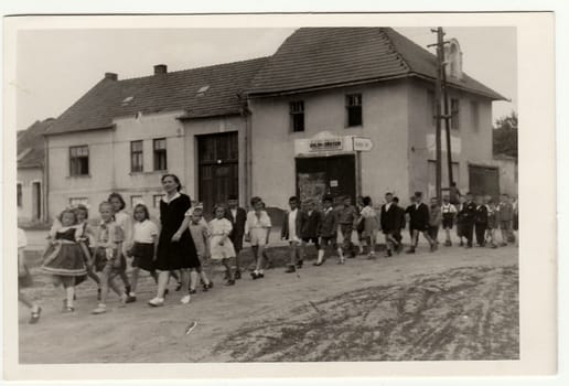 THE CZECHOSLOVAK SOCIALIST REPUBLIC - CIRCA 1940s: Vintage photo shows female teacher with her pupils go for a walk.