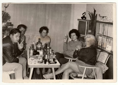 THE CZECHOSLOVAK SOCIALIST REPUBLIC - CIRCA 1970s: Vintage photo shows women and men at the home party.