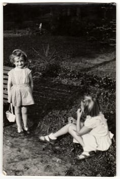 THE CZECHOSLOVAK SOCIALIST REPUBLIC - CIRCA 1950s: A vintage photo shows small girls outdoors.