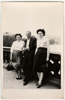 THE CZECHOSLOVAK SOCIALIST REPUBLIC - CIRCA 1960s: Vintage photo shows women and man stand on the bridge.