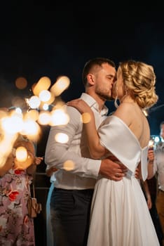 newlyweds at a wedding in the corridor of sparklers