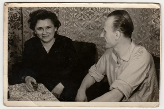 THE CZECHOSLOVAK SOCIALIST REPUBLIC - CIRCA 1960s: Vintage photo shows woman and man drink spirits (liquors).