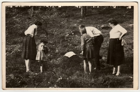 THE CZECHOSLOVAK SOCIALIST REPUBLIC - 1970s: Vintage photo shows family looks at anthill.