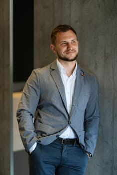 portrait of smiling groom with beard in blue color suit