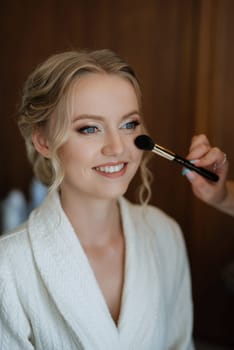 morning of the bride with the creation of the image of makeup and the creation of hairstyles