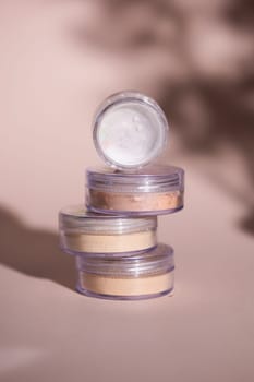 Mineral powder of beige and tan colors on pale rose colour background
