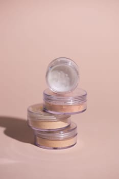 Mineral powder of beige and tan colors on pale rose colour background