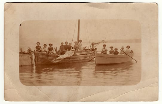 THE CZECHOSLOVAK REPUBLIC - CIRCA 1920: Vintage photo shows children on a boat trip. Antique black white photo with sepia tint.