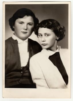 THE CZECHOSLOVAK SOCIALIST REPUBLIC - CIRCA 1950: Vintage studio portrait photo shows young girls. Antique black white photo.