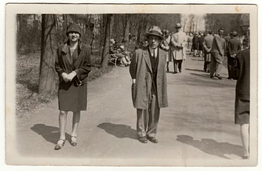 PREROV, THE CZECHOSLOVAK REPUBLIC - APRIL 26, 1928: Vintage photo shows young man and woman pose in the city park.