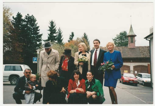 SWITZERLAND - CIRCA 1995: Vintage photo shows people pose after family celebration.