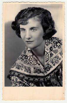 HODONIN, THE CZECHOSLOVAK REPUBLIC - CIRCA 1920s: Vintage studio photo portrait shows woman in a folk costum.