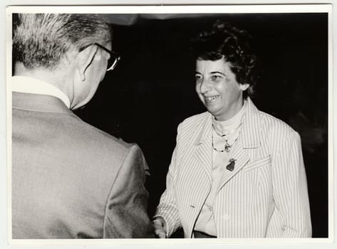 THE CZECHOSLOVAK REPUBLIC - 1991: Vintage photo shows man congratulations woman.