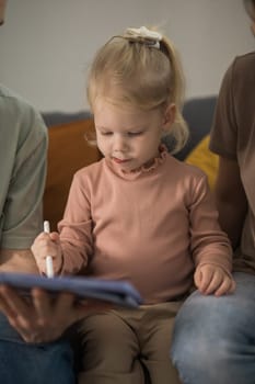 Deaf child girl with cochlear implant studying to hear sounds - recovery after cochlear Implant surgery and rehabilitation