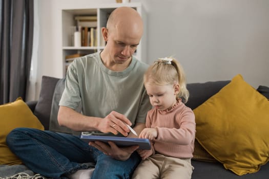 Deaf child girl with cochlear implant studying to hear sounds - recovery after cochlear Implant surgery and rehabilitation