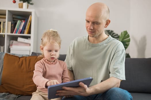 Deaf child girl with cochlear implant studying to hear sounds - recovery after cochlear Implant surgery and rehabilitation