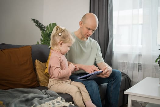 Deaf child girl with cochlear implant studying to hear sounds - recovery after cochlear Implant surgery and rehabilitation