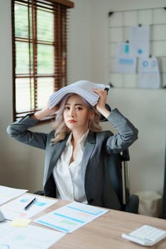 Portrait of sme business owner, woman using computer and financial statements Anxious expression on expanding the market to increase the ability to invest in business.