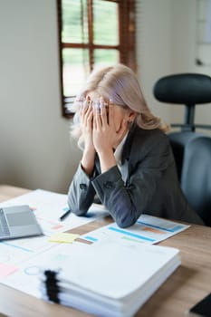 Portrait of sme business owner, woman using computer and financial statements Anxious expression on expanding the market to increase the ability to invest in business.