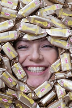 The face of a caucasian woman surrounded by Rakhat chocolates