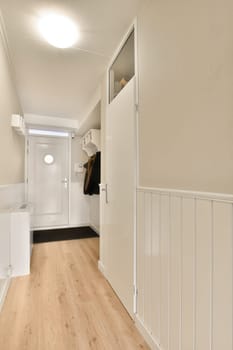 a hallway with wood flooring and white painted walls in an empty room that has been used for several years