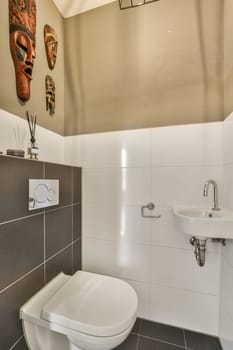 a toilet and sink in a bathroom with white tiles on the wall behind it is an image of a man's face