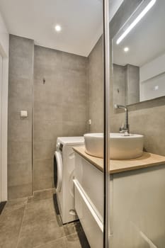 a bathroom with a toilet, sink and mirror in the corner between it to the shower stall on the right side