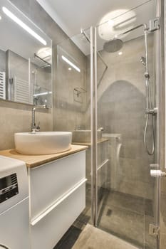 a bathroom with a sink, mirror and shower stall in the corner next to it is a white wash basin