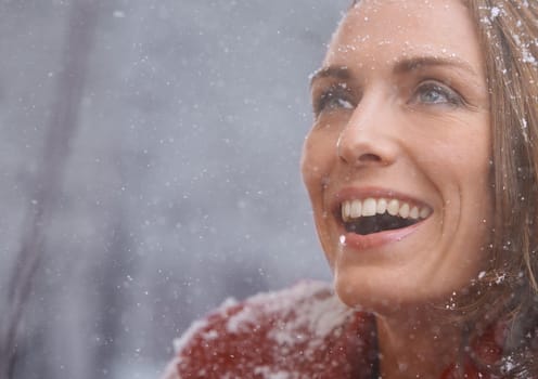 Braving the outdoors isnt all bad. Closeup shot of a happy woman outdoors in winter