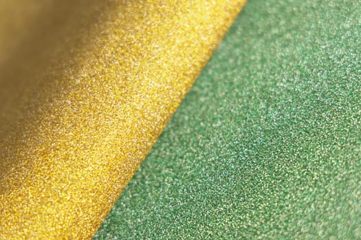 Yellow and green wave shiny glitter paper texture. Shining luxurious fabric. Glimmering light green golden color, christmas background