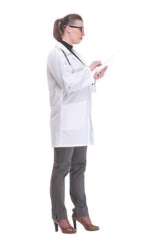 Full lenth portrait of a happy young doctor working with a tablet, on white background