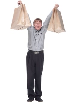 full length. happy mature man showing his shopping bags. isolated on a white background.