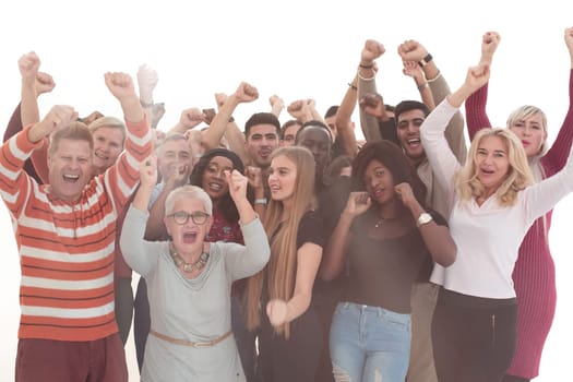 close up. group of happy people standing with their hands up .