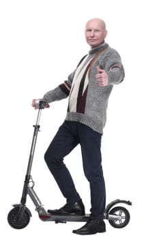 side view. mature man with electric scooter looking at you. isolated on a white background.