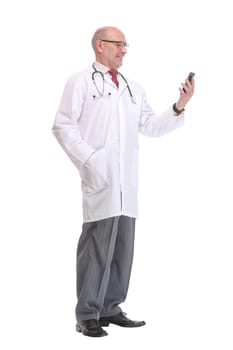 Portrait of happy senior smiling doctor holding smartphone. White isolated background.