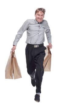 full length.cheerful man with shopping bags hurries to the sale. isolated on a white background.